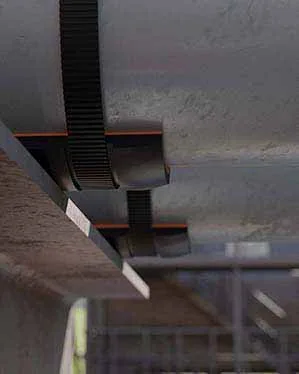 an image of a model that shows two sections of pipe with installed smartpads, resting on a steel pipe support that is protecting the pipes from corrosion