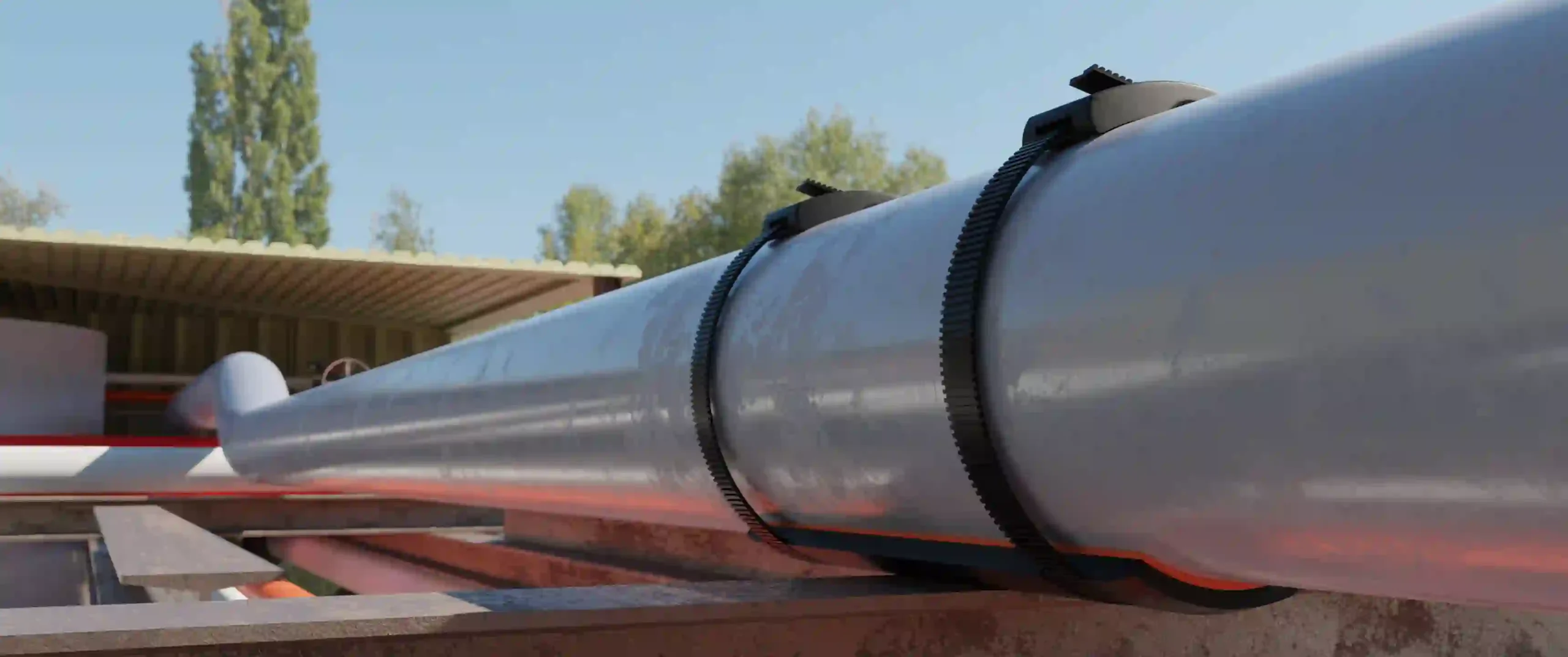 "SmartPad pipe support system securing a metallic pipeline on a structural steel beam in an outdoor refinery setting"
